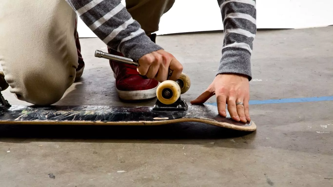 unassembling skateboard trucks while painting skateboard decks